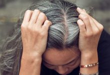 woman parting her gray hair down the middle