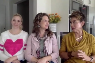 3 women sitting side by side talking to each other