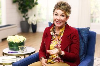Carol on chair talking about childhood
