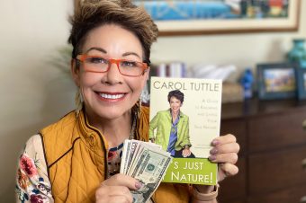 Carol Tuttle holding money with the book It's Just My Nature