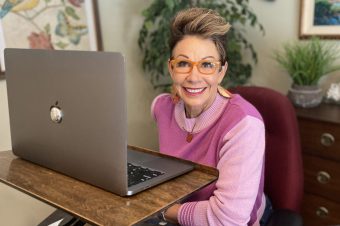 Carol in front of her laptop - how to look great on zoom
